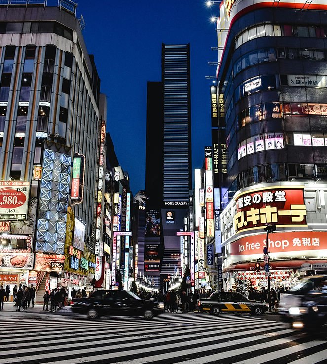 Shinjuku district neon lights and buildings at night in Tokyo